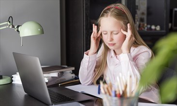 Girl having headache after online class