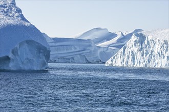 Huge icebergs in the UNESCO World Heritage Ilulissat Icefjord seen from a boat. Ilulissat