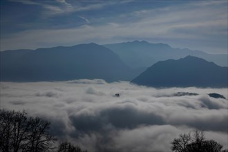 Mountain Peak Above Cloudscape in a Sunny Day in Lugano