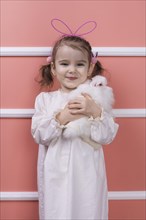 Cute little girl bunny ears with rabbit