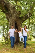 Vertical photo of a playful family spending time in a forest together