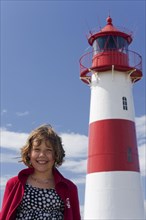 Girl in front of a lighthouse
