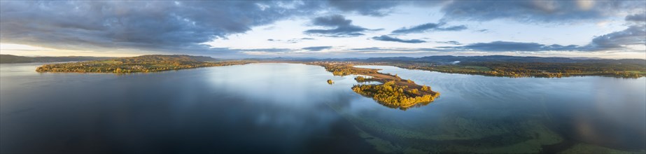 Aerial panorama of the Mettnau peninsula in western Lake Constance illuminated by the morning sun