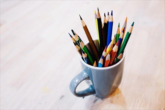 Cup with colored pencils