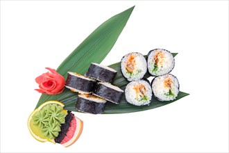 Overhead view of sushi roll with smoked eel with cucumber served on bamboo leaves