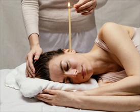 Close up therapist using candle