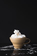 Coffee cup with whipped cream black surface