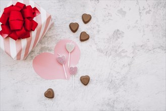 Lollipops near chocolate sweet candies paper heart present box