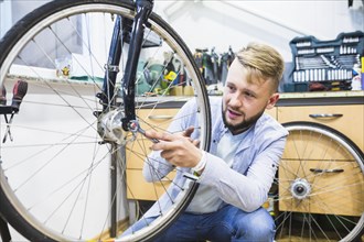 Man repairing bicycle tire with wrench