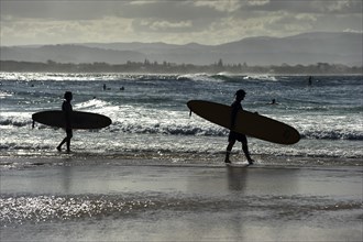 Surfer silhouette on the beach of Byron bay