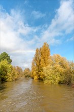 Rainbow over a flooded river. Landscape in autumn. Bas-Rhin