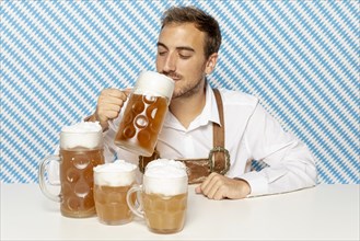 Front view man drinking blonde beer