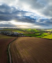 Panorama of Lights and Shadows over Fields and Farms from a drone