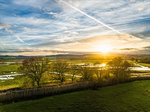 Sunset over Wetlands and Marshes in RSPB Exminster and Powderham Marshe from a drone