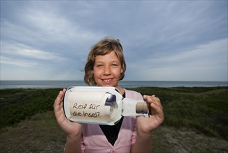 Child with message in a bottle