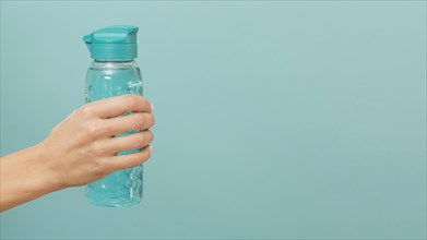 Fitness bottle filled with water copy space