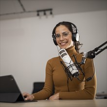 Low angle woman broadcasting radio