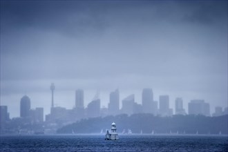 Skyline with lighthouse from Watson bay in the rain