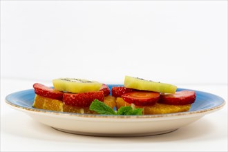 Fresh summer fruit salad on a white background