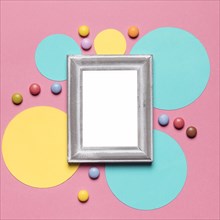 Empty blank frame with silver border circular frame with colorful gems pink background