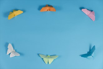 Blue background with frame made butterflies