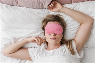Female wearing sleep mask her eyes