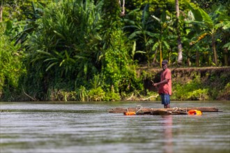 Man on a wooden raft