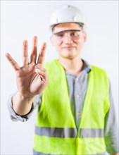 Young engineer counting number four isolated. Male engineer showing number four with fingers isolated