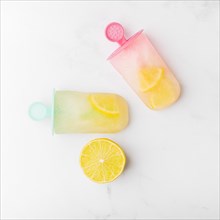 Cut lemon fresh ice popsicle with citrus colorful sticks