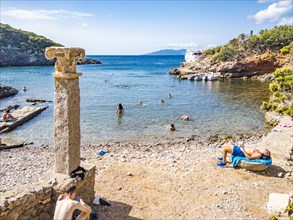 Bathers in the ancient Roman ruins of Cala Maestra