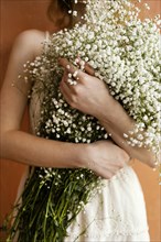 Front view woman holding bouquet flowers