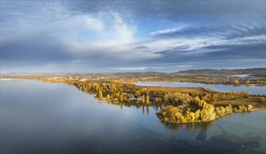 Aerial panorama of the Mettnau peninsula in western Lake Constance illuminated by the morning sun with the spa centre