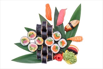Overhead view of big set of sushi and rolls served on bamboo leaves