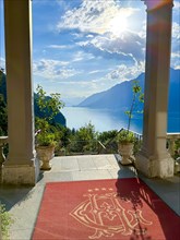 Grandhotel Giessbach Entrance with View over Lake Brienz and Mountain with Sunlight in a Sunny Summer Day in Brienz