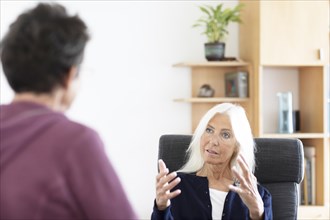 Therapist talking to a patient in a practice