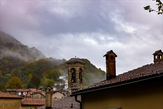 Alpine Village Bre with Autumn Forest and Mountain in a Cloudy Day in Monte Bre
