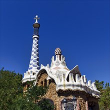 Mosaics decorate the tower and roof of a house