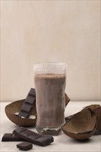Front view chocolate milkshake glass with coconut copy space