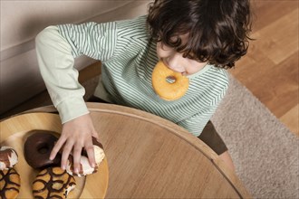 Kid eating doughnuts home