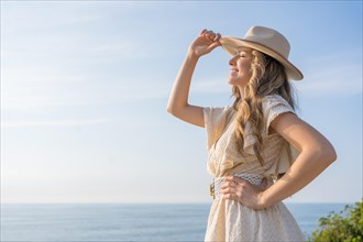 Horizontal photo with copy space of a stylish woman in summer clothes gazing the sea
