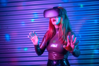 Beauty woman gesturing while wearing VR goggles in an urban night space with neon lights