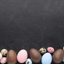 Flat lay colorful easter eggs chocolate ones