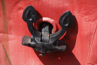 Anchor on a red ship's side