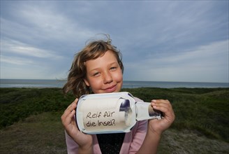 Child with message in a bottle
