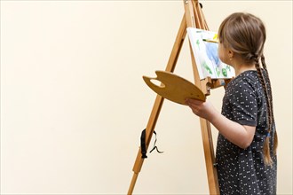 Girl with down syndrome painting with copy space