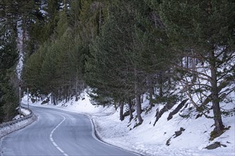 Road in the snowy mountains of the Pyrenees in Andorra during winter