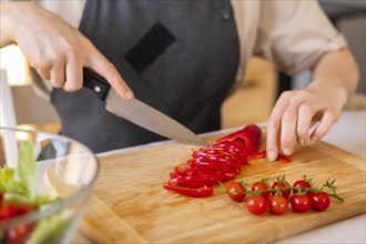 Close up hand cutting pepper