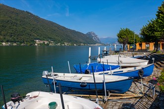 Port with Boats in Brusino Arsizio on the Waterfront in a Sunny Summer Day on Lake Lugano and Mountain in Brusino Arsizio