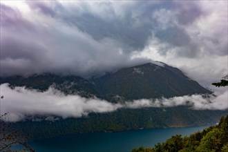 Aerial View over Lake Lugano in Valley with Mountainscape with Storm Clouds in Lugano