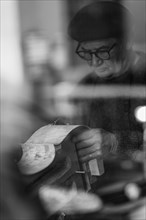 Senior expet luthier artisan violinmaker carve chisel rib of new classic cello in workshop Cremona Italy